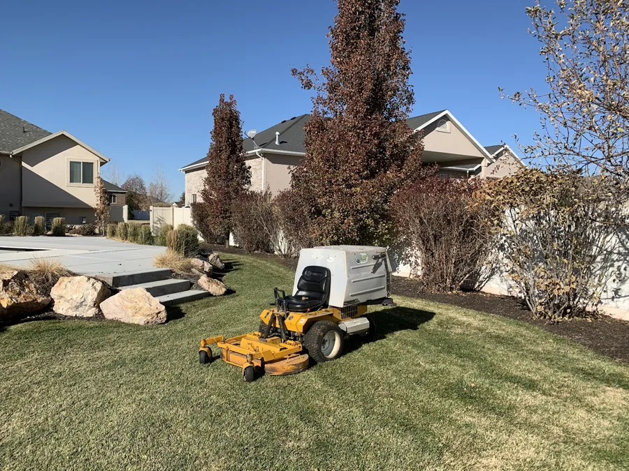 Commercial mower cutting a sloped front lawn