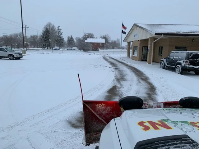 View over the plow blade across a freshly plowed lot