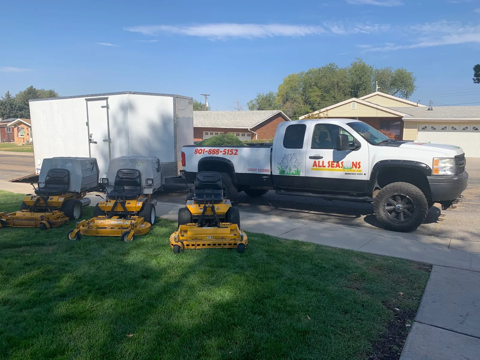 All Seasons truck and three commercial mowers on a fresh-cut lawn in Roy, UT